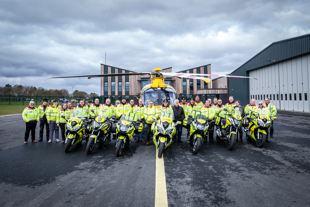 AN outdoor image of a large group of people on motorbikes.